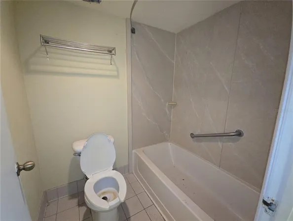 a bathroom with a shower and toilet
