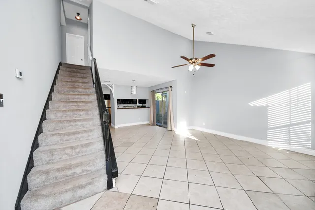 a view of an empty room with a fireplace and a window