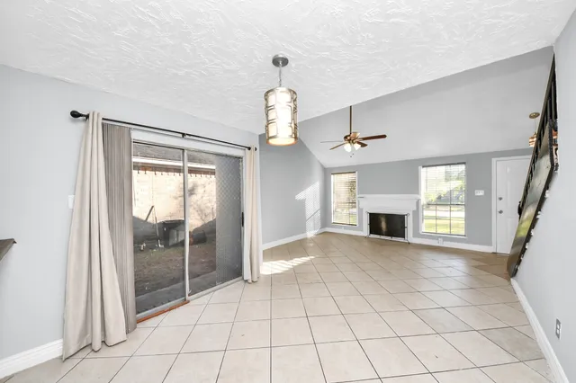 a view of a hallway to kitchen and a window