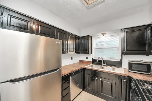 an empty room with wooden floor and ceiling fan