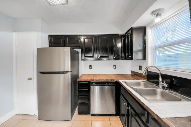 an empty room with a window and ceiling fan