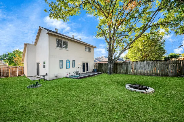 a white house that has a tree in front of it