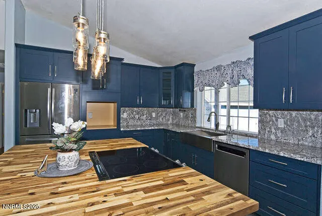 a kitchen with a sink appliances and cabinets