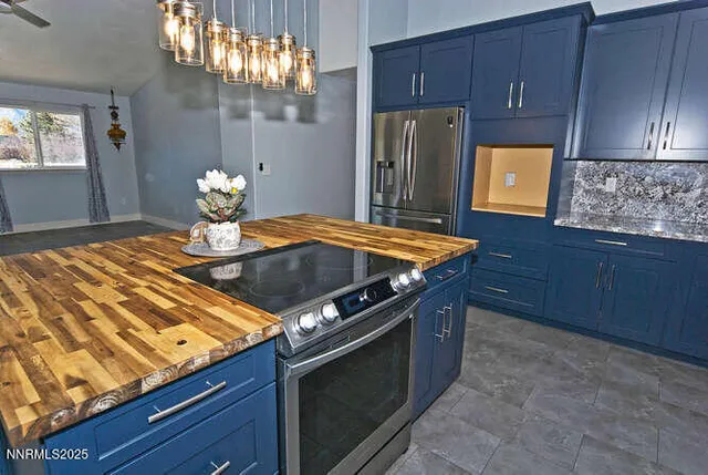 a kitchen with stainless steel appliances granite countertop a sink and a refrigerator