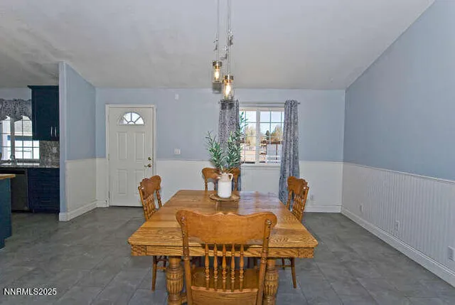 a dining room with a table and chairs
