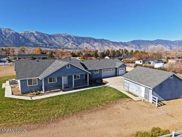an aerial view of a house with a big yard