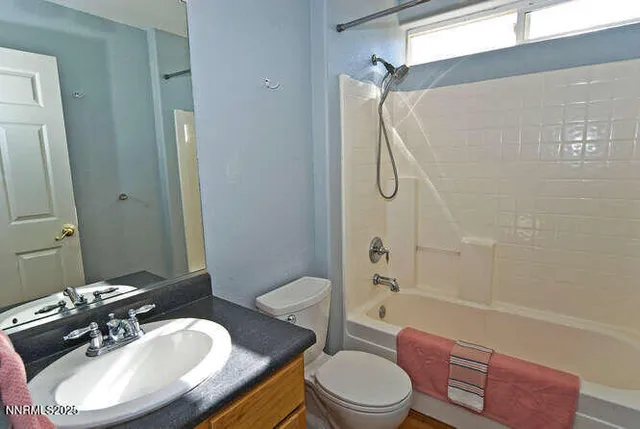 a bathroom with a sink toilet a mirror and shower