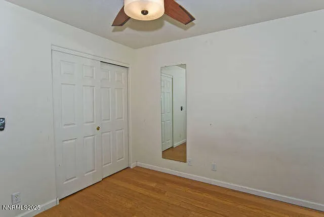 an empty room with wooden floor and closet