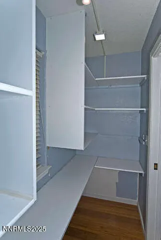 a view of walk in closet with empty racks
