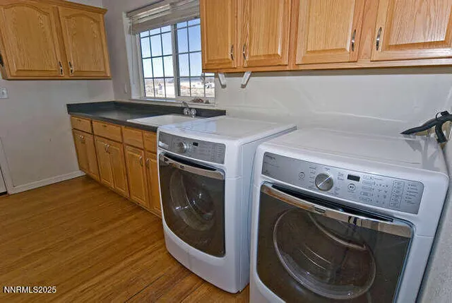 a utility room with sink dryer and washer