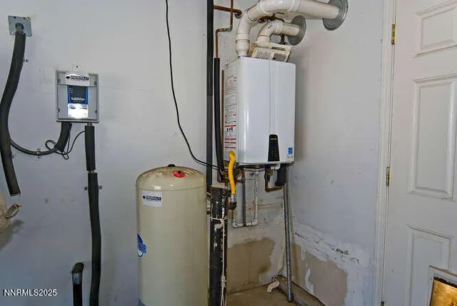a view of a chairs and table on the patio and a lake view