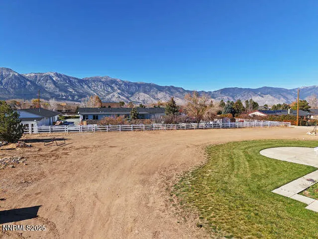 a view of a house with a yard and sitting area