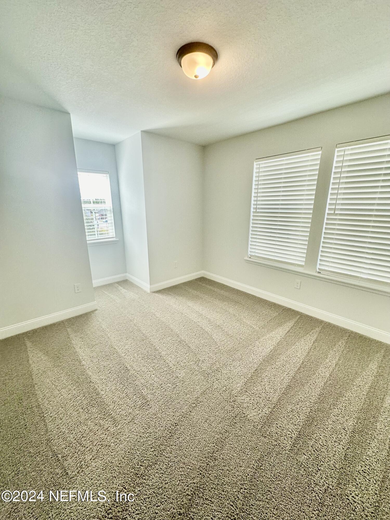 236 Wildlight Avenue Yulee, FL 32097 - Photo 4 of 10 an empty room with windows