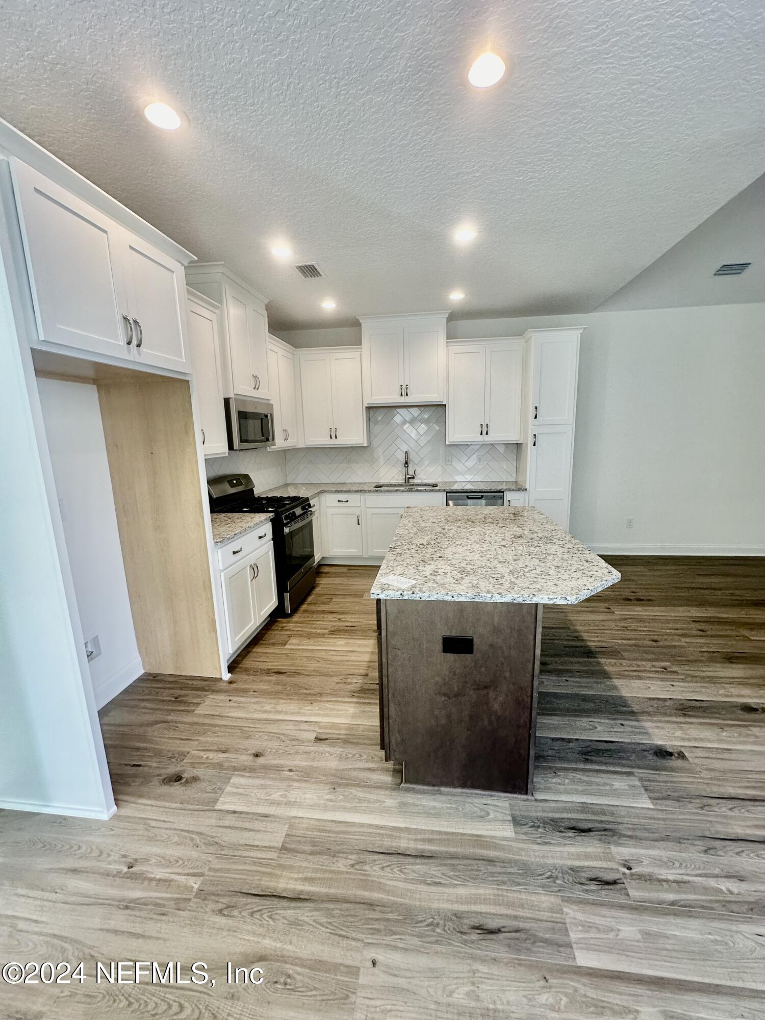 236 Wildlight Avenue Yulee, FL 32097 - Photo 8 of 10 a view of kitchen with wooden floor