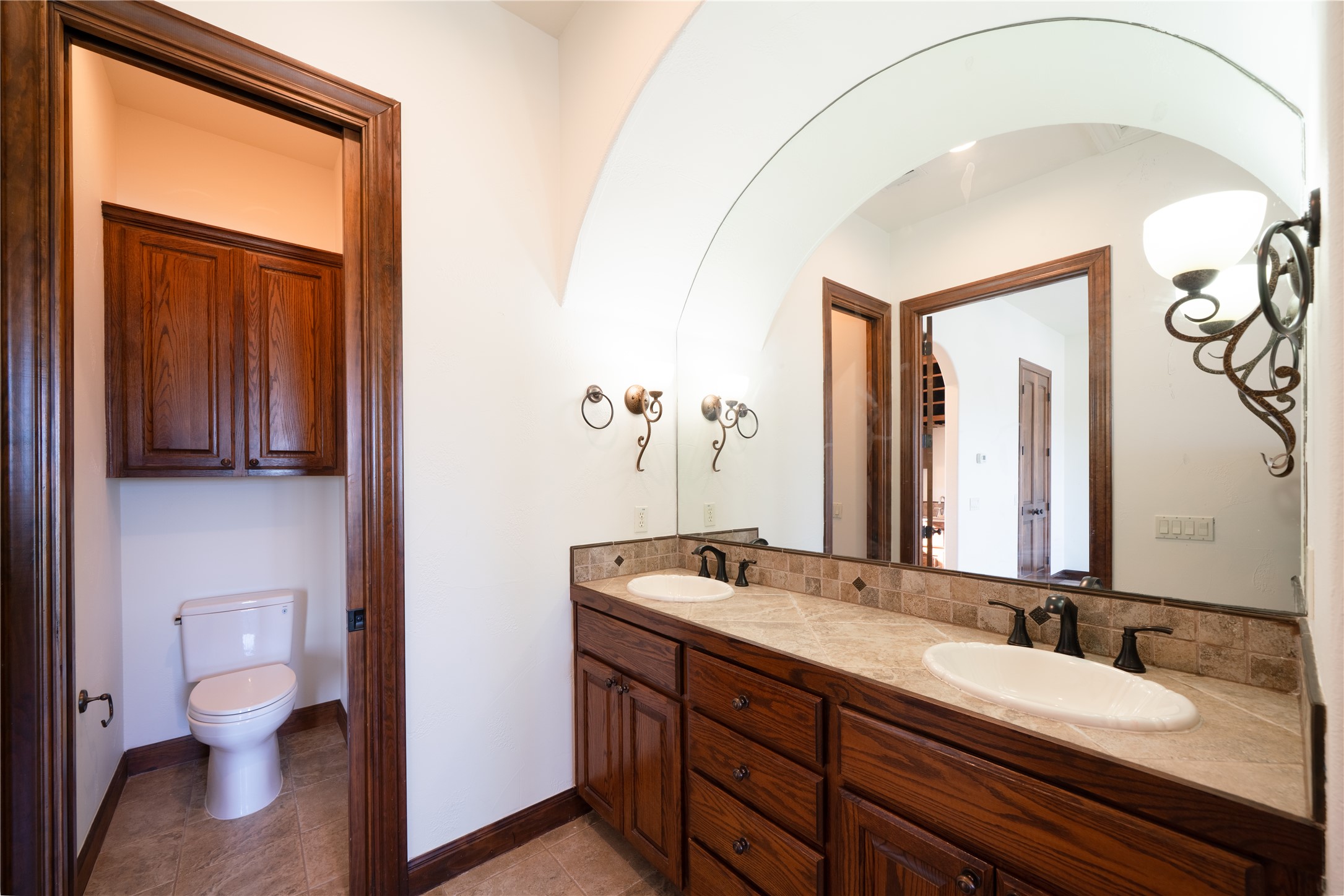 17545 West Reed Park Road, Unit 2 Jonestown, TX 78645 - Photo 23 of 39 a bathroom with a granite countertop sink mirror and toilet