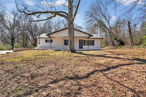 a view of a house with a yard covered with snow