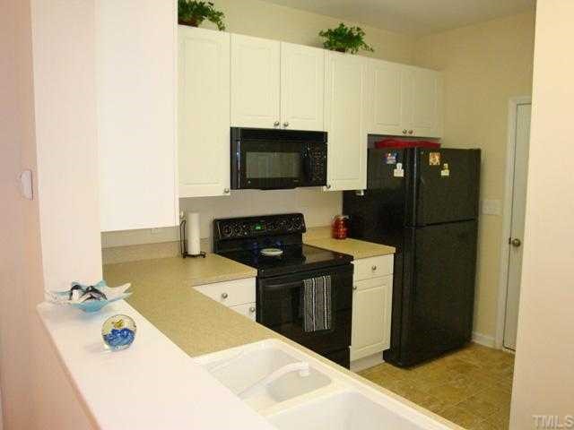 2320 Persimmon Ridge Drive Raleigh, NC 27604 - Photo 3 of 11 a kitchen with a stove and a refrigerator