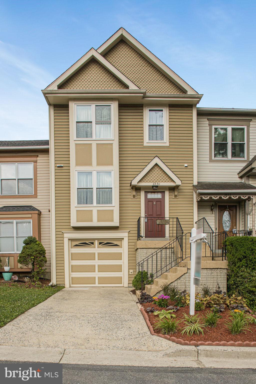 2830 Schoolhouse Circle Silver Spring, MD 20902 - Photo 1 of 58 a front view of a house with garden