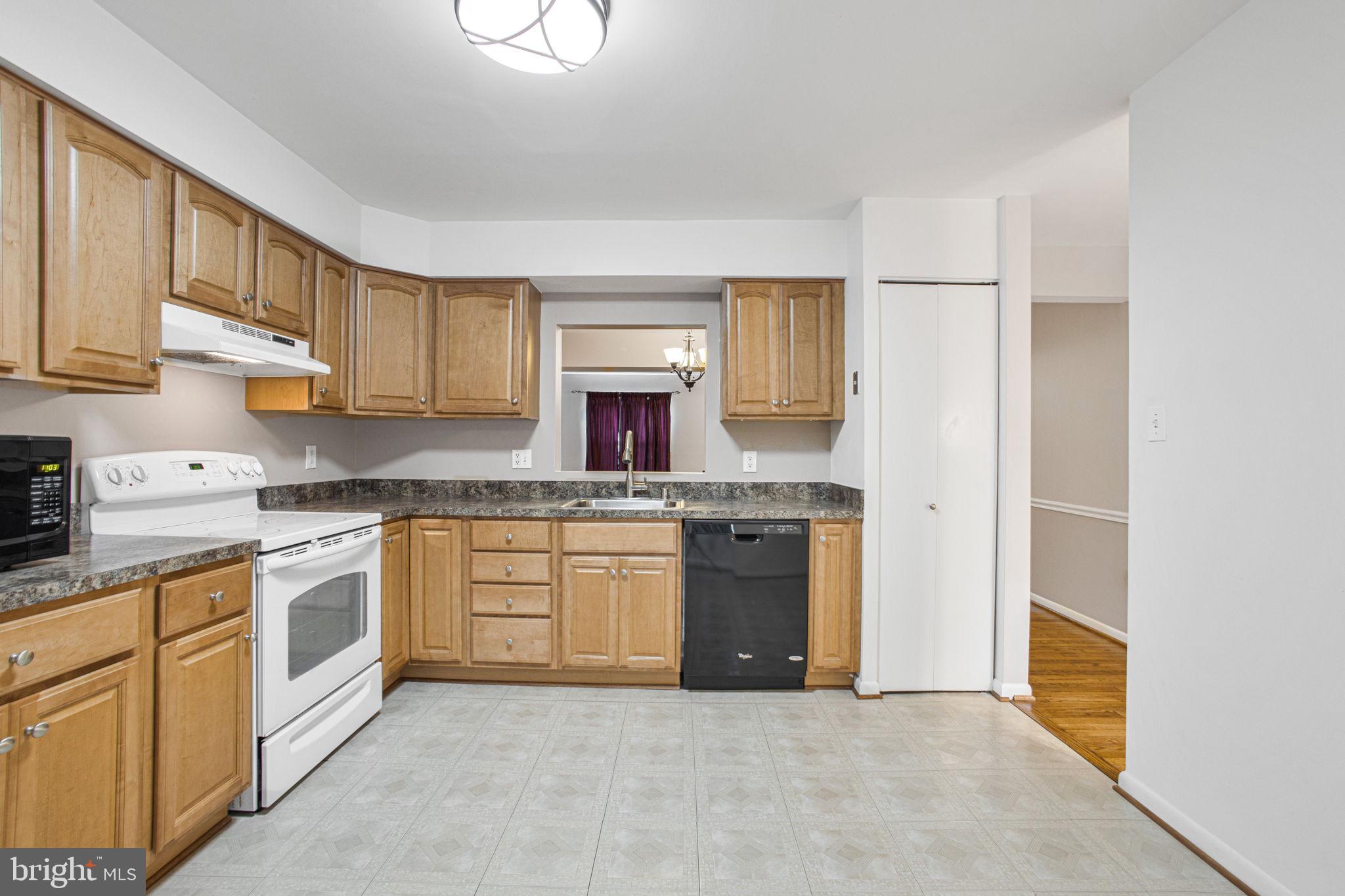 2830 Schoolhouse Circle Silver Spring, MD 20902 - Photo 16 of 58 a kitchen with stainless steel appliances granite countertop a refrigerator and a stove top oven
