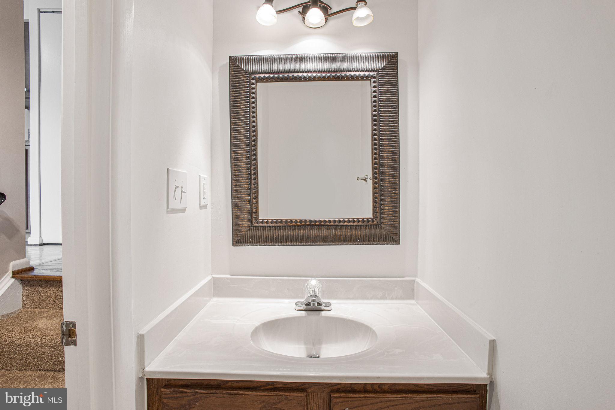 2830 Schoolhouse Circle Silver Spring, MD 20902 - Photo 19 of 58 a bathroom with a sink and a mirror
