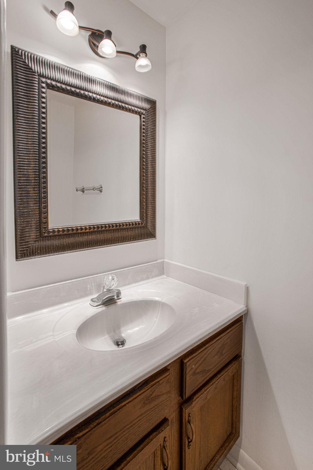 2830 Schoolhouse Circle Silver Spring, MD 20902 - Photo 20 of 58 a bathroom with a sink vanity and a mirror