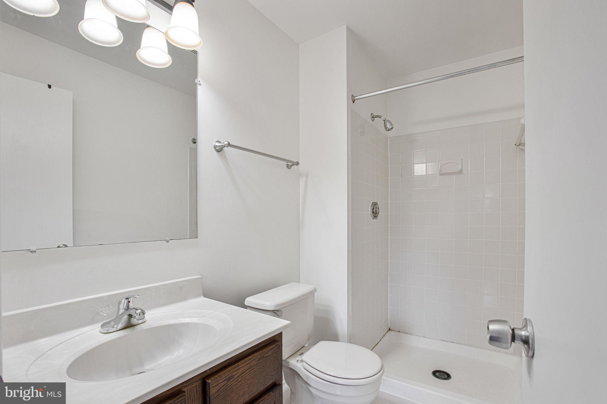 2830 Schoolhouse Circle Silver Spring, MD 20902 - Photo 24 of 58 a bathroom with a sink toilet and shower