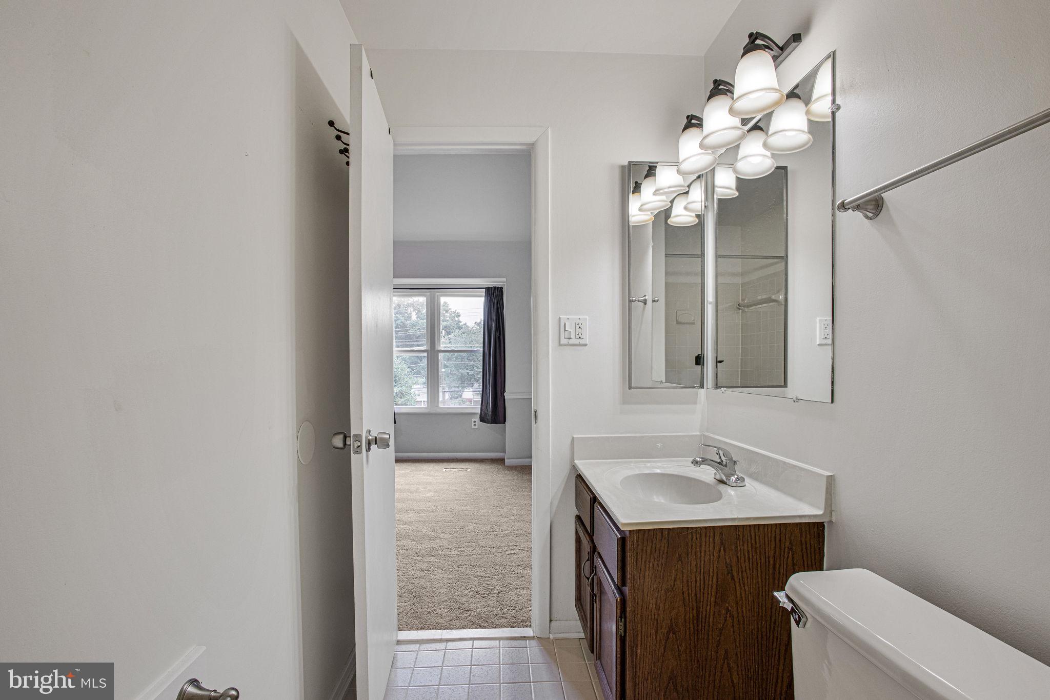 2830 Schoolhouse Circle Silver Spring, MD 20902 - Photo 25 of 58 a bathroom with a sink toilet and mirror