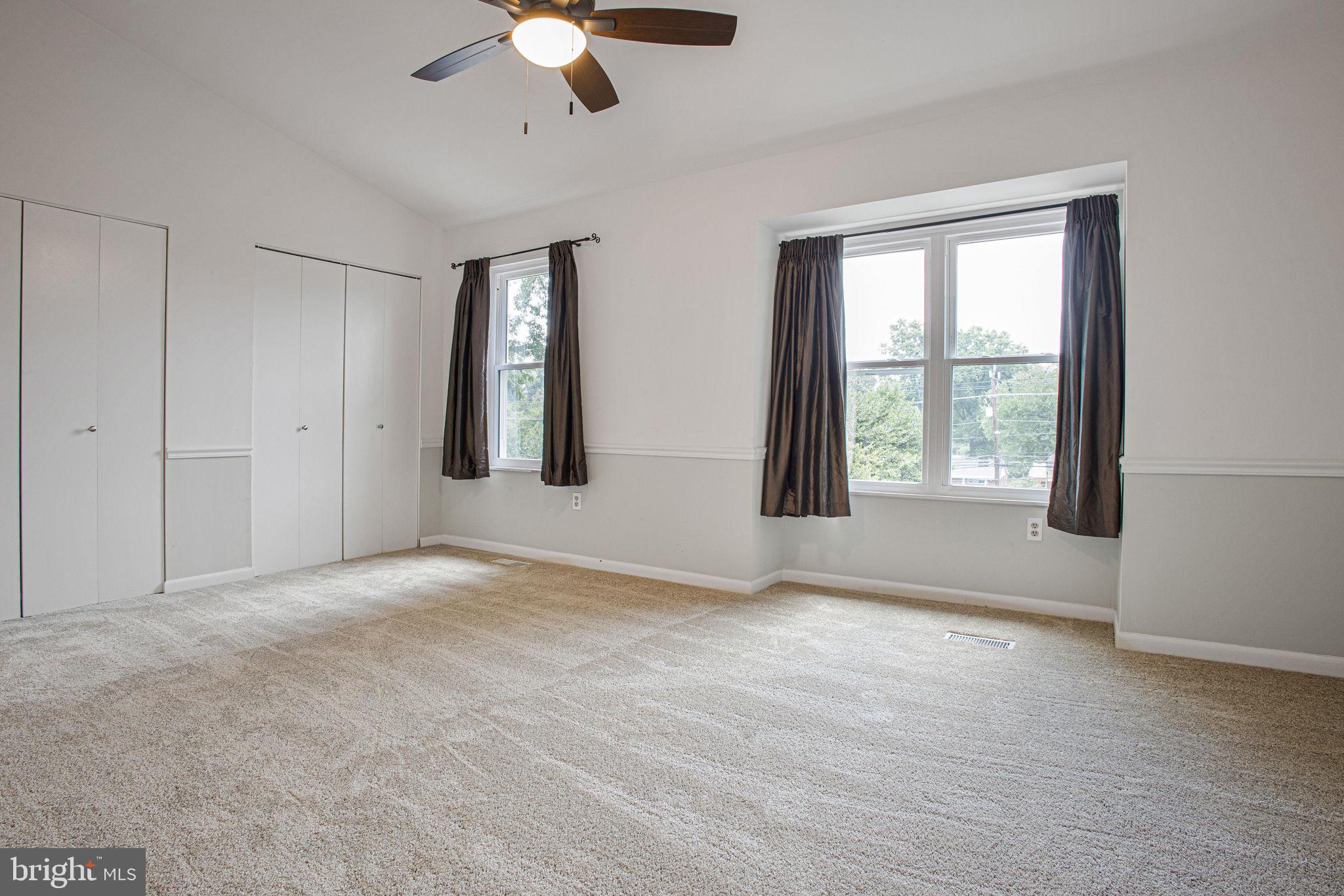 2830 Schoolhouse Circle Silver Spring, MD 20902 - Photo 26 of 58 an empty room with windows and chandelier fan