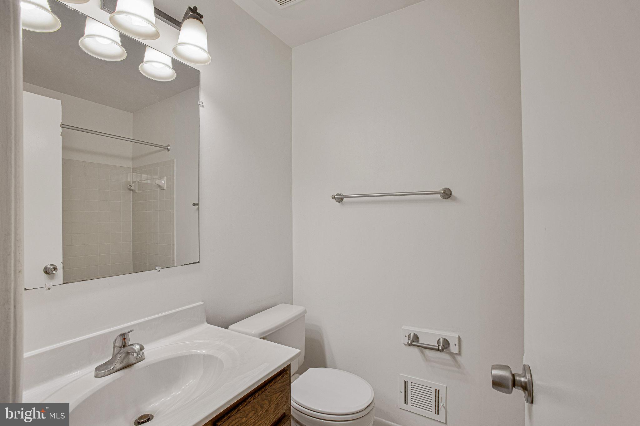 2830 Schoolhouse Circle Silver Spring, MD 20902 - Photo 28 of 58 a bathroom with a sink vanity mirror and toilet