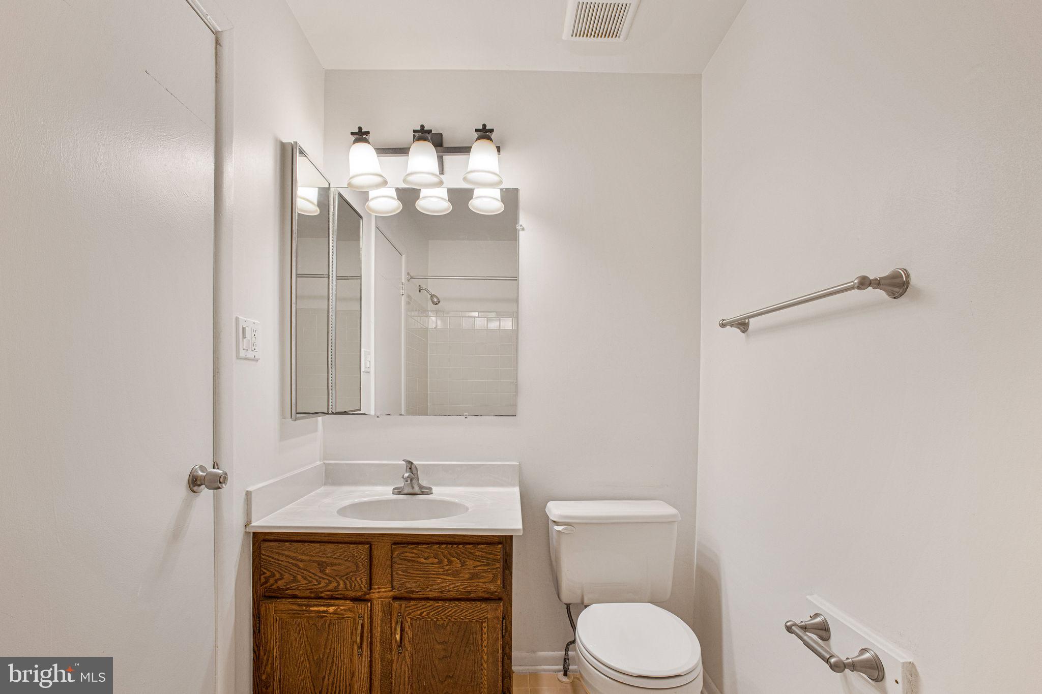2830 Schoolhouse Circle Silver Spring, MD 20902 - Photo 29 of 58 a bathroom with a toilet sink and mirror