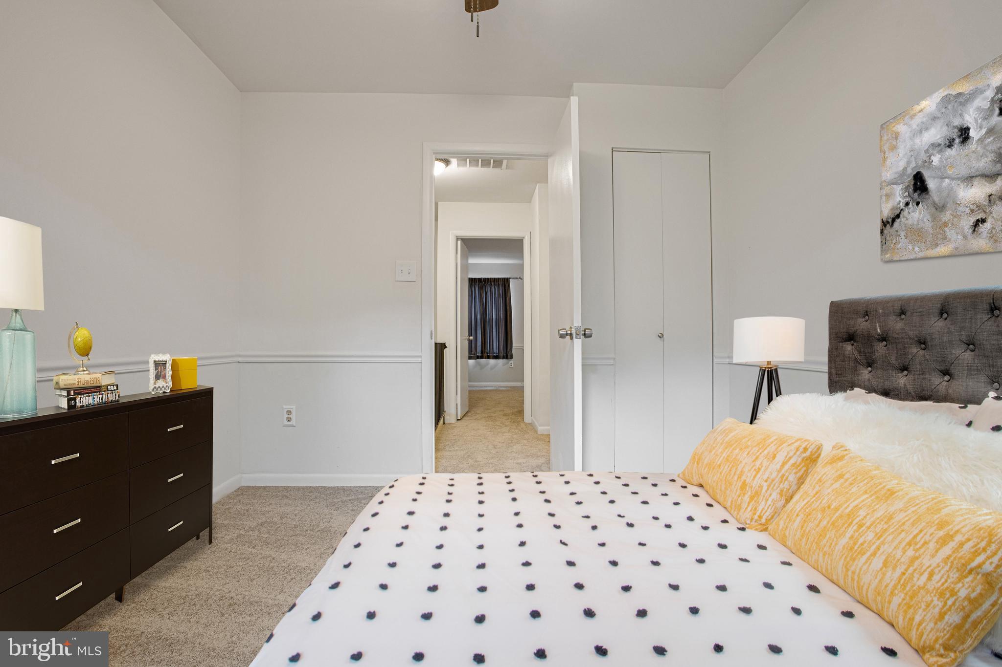 2830 Schoolhouse Circle Silver Spring, MD 20902 - Photo 30 of 58 a bedroom with a bed and lamp