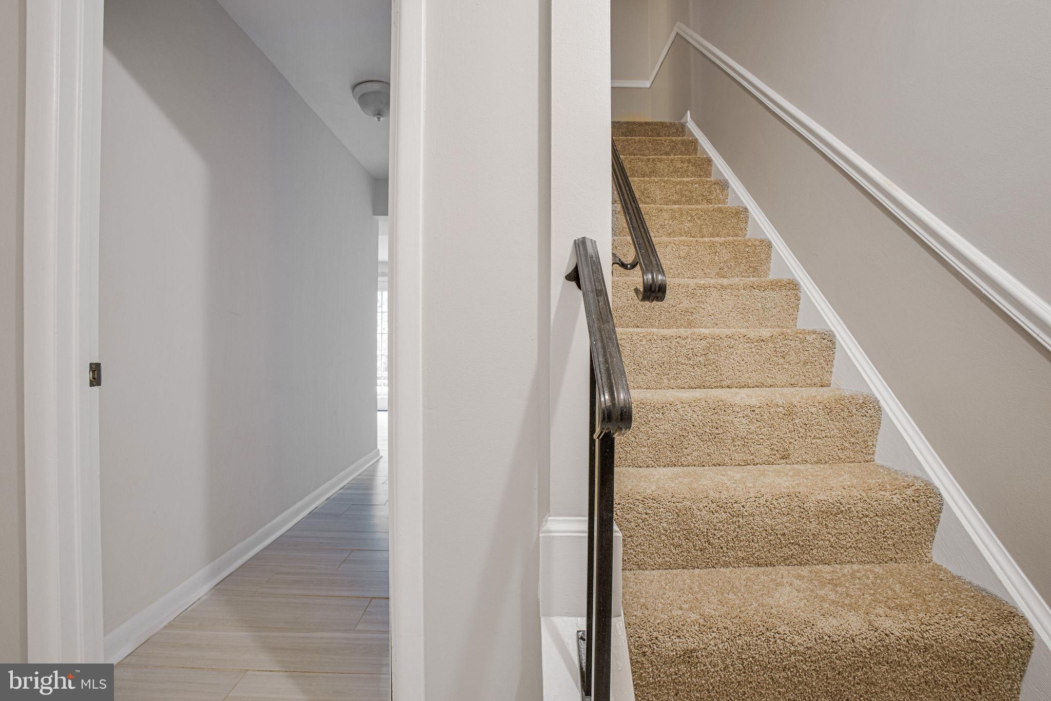 2830 Schoolhouse Circle Silver Spring, MD 20902 - Photo 36 of 58 a view of staircase with white walls and railing