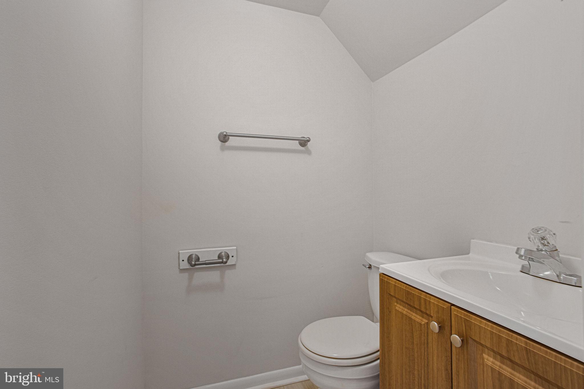 2830 Schoolhouse Circle Silver Spring, MD 20902 - Photo 37 of 58 a bathroom with a granite countertop toilet a sink and a mirror