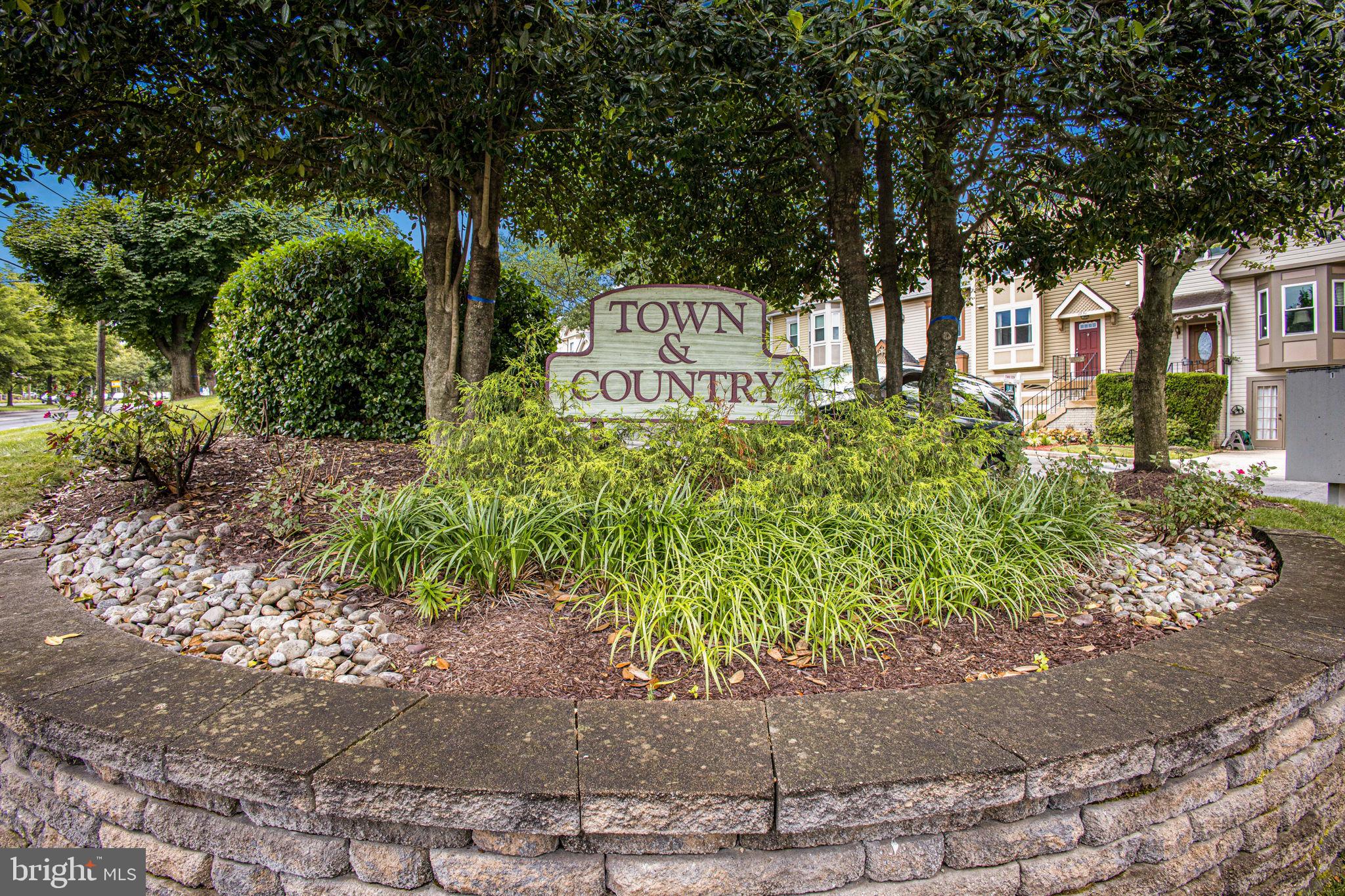 2830 Schoolhouse Circle Silver Spring, MD 20902 - Photo 55 of 58 a front view of a house with a yard and a garden