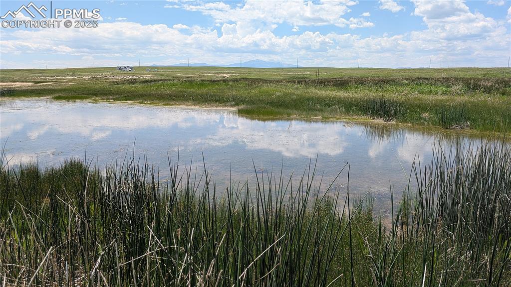 7995 Cowboy Rnch View Peyton, CO 80831 - Photo 1 of 24 a view of lake with green space