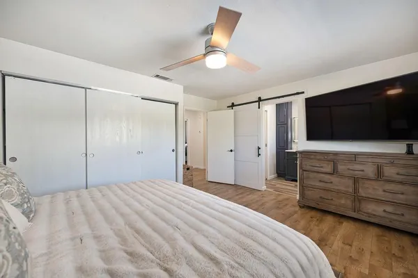 a bedroom with a bed and a flat screen tv