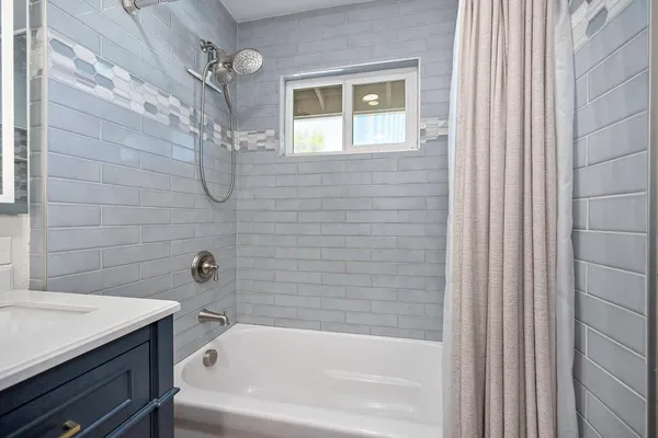 a bathroom with a bathtub and shower
