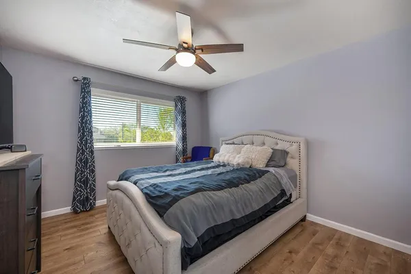 a bedroom with a bed and a window