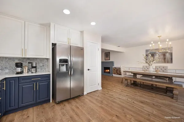 a kitchen with stainless steel appliances granite countertop a refrigerator and a stove top oven
