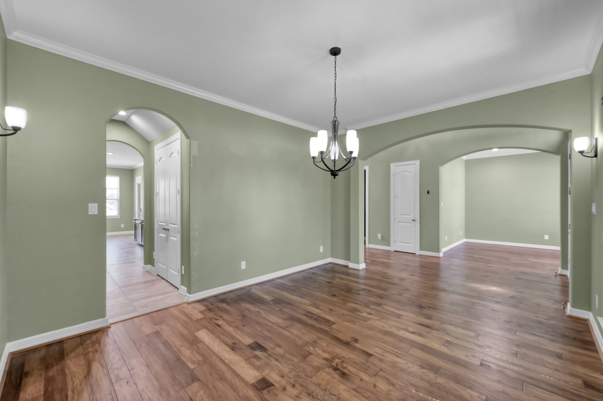 23219 Belted Kingfisher Trail Spring, TX 77389 - Photo 7 of 43 a view of a room with a chandelier fan and wooden floor