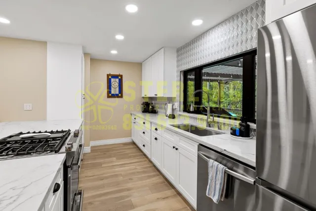 a kitchen with a sink a counter and cabinets