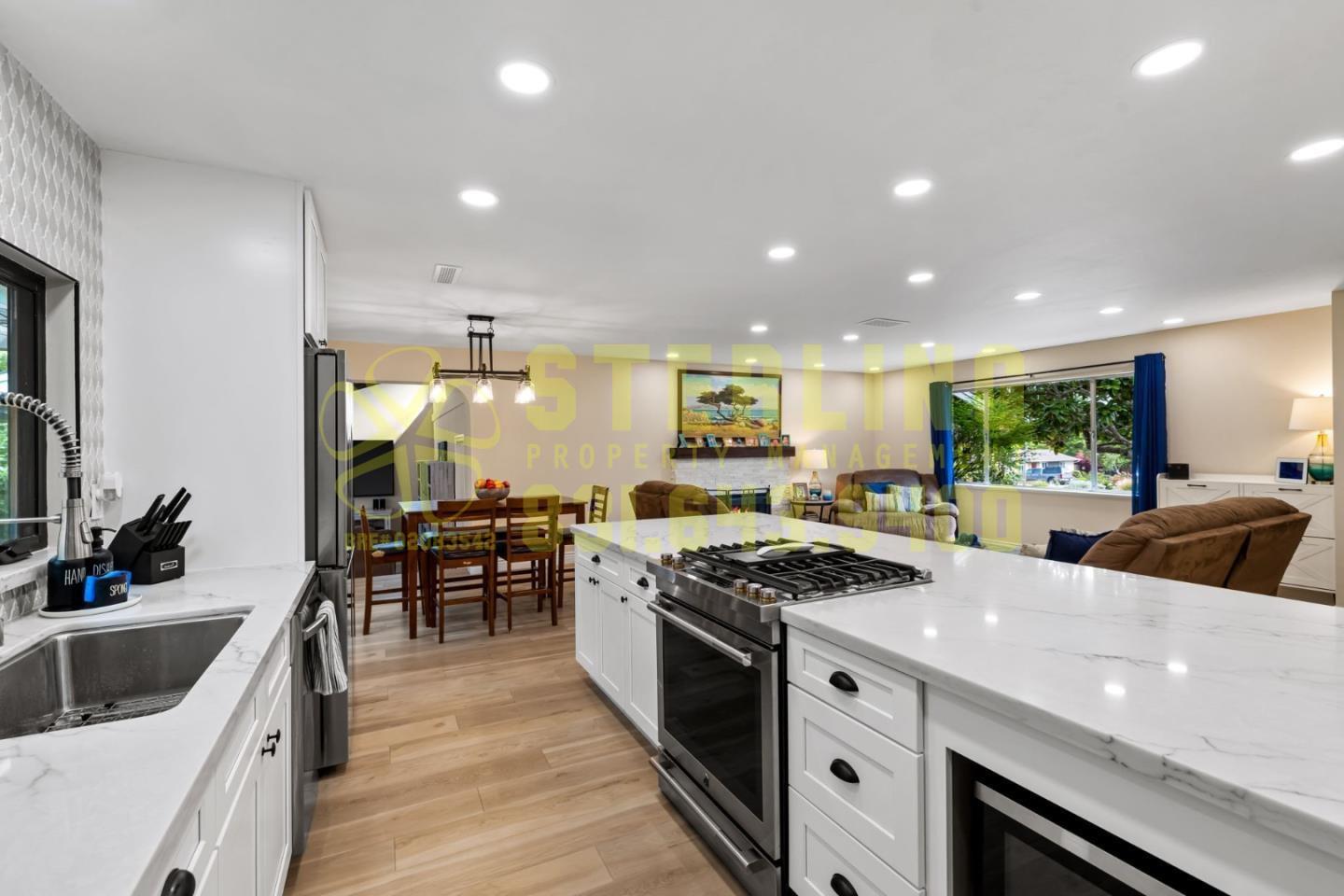 2040 Marsala Circle Monterey, CA 93940 - Photo 15 of 42 a kitchen with stainless steel appliances a sink a stove a table and chairs