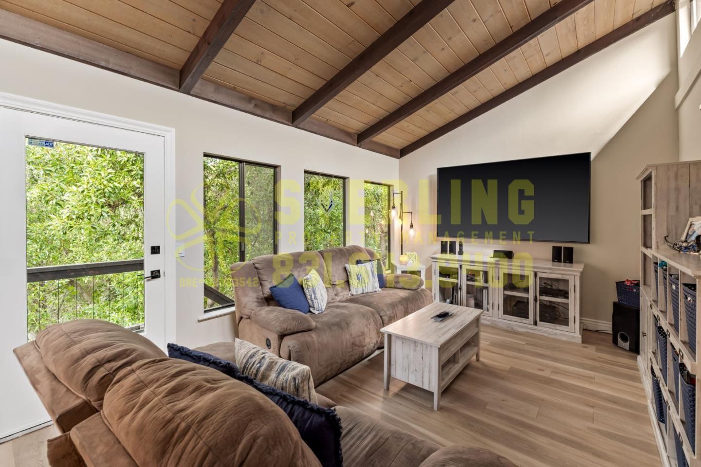 2040 Marsala Circle Monterey, CA 93940 - Photo 21 of 42 a living room with furniture a flat screen tv and floor to ceiling window