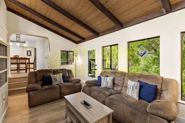 a view of a workspace with furniture and wooden floor