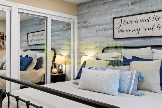 a spacious bedroom with a bed and glass door