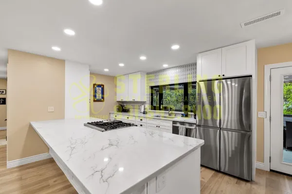 a kitchen with a sink a stove and a refrigerator