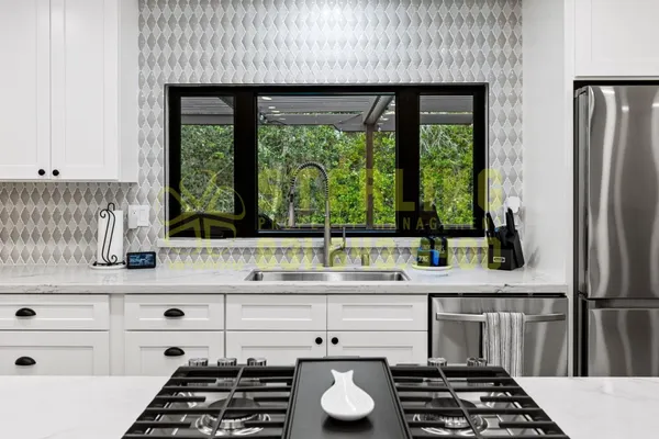 a kitchen with stainless steel appliances granite countertop a stove and a refrigerator
