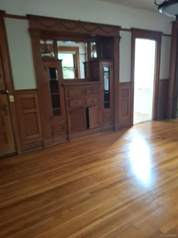a view of a livingroom with furniture wooden floor and window
