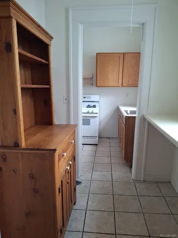 a kitchen with a refrigerator and a stove