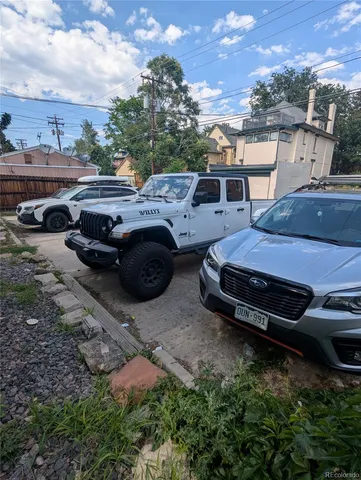 a view of a backyard and car parked
